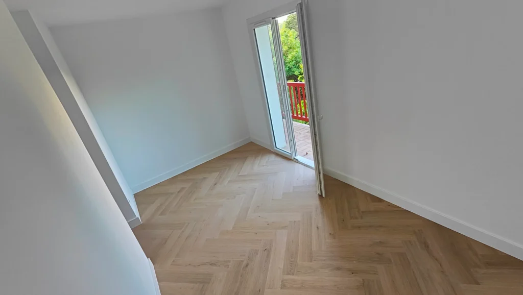 Pasillo terminado con suelo en espiga de roble natural Quick-Step y rodapié blanco — Saint-Jean-de-Luz, Reformas Ordoñez